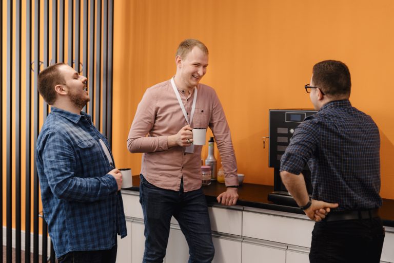 3 employees enjoying a cup of coffee from office coffee vending machine
