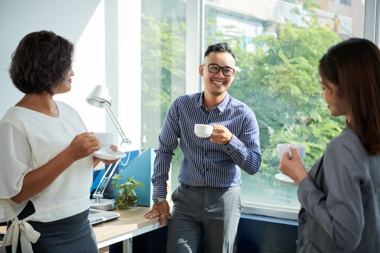 employees drinking coffee from coffee vending machine